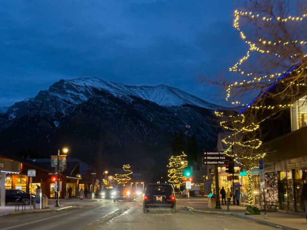 Banff Avenue lit up with Christmas lights in December.