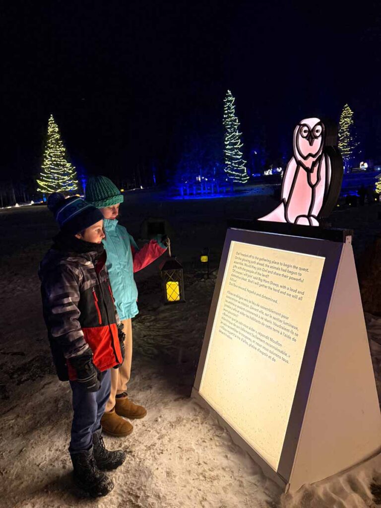 Brewer kids hold a lit lantern while visiting In Search of Christmas Spirit in Banff.