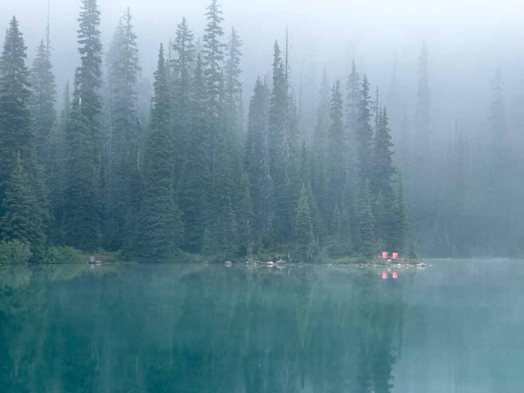 Parks Canada Red Chairs on the shore of a misty Yoho Lake in August.