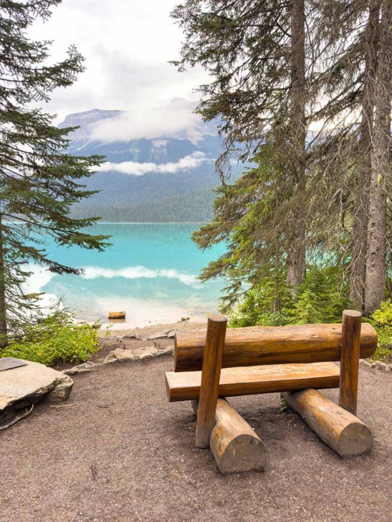 A park bench with a view of Emerald Lake along the lakeshore trail.