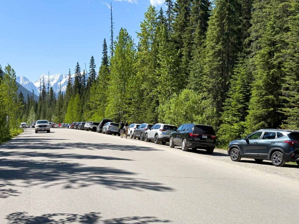 Cars park on Emerald Lake Road as the main parking lot is full.