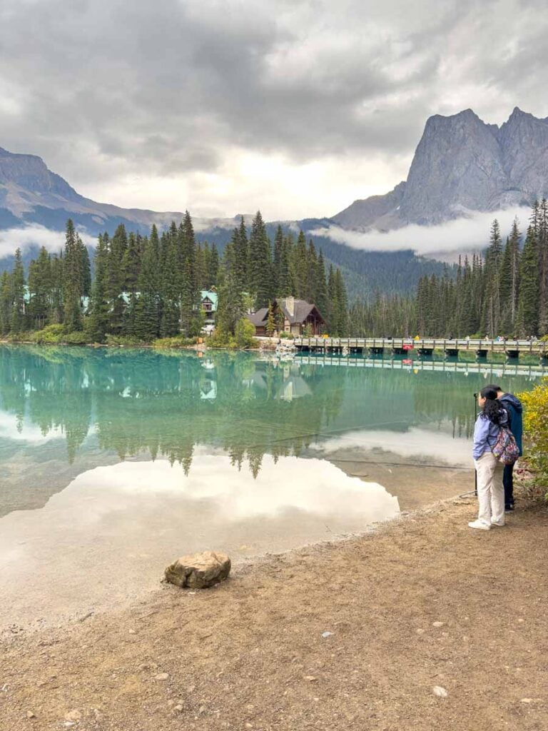A couple stands on the western shore of Emerald Lake in Yoho National Park.
