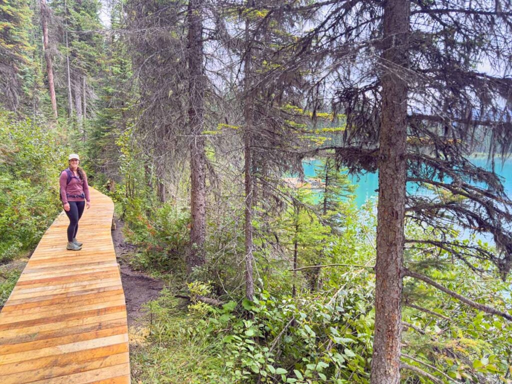 Celine Brewer, host of the Banff Travel Podcast, walks on a new wooden boardwalk along the Emerald Lakeshore Trail.