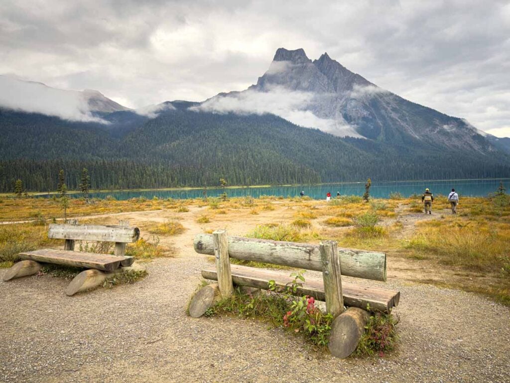 Two park benches along the Emerald Lakeshore Trail mark the trail junction for the Emerald Basin Trail.