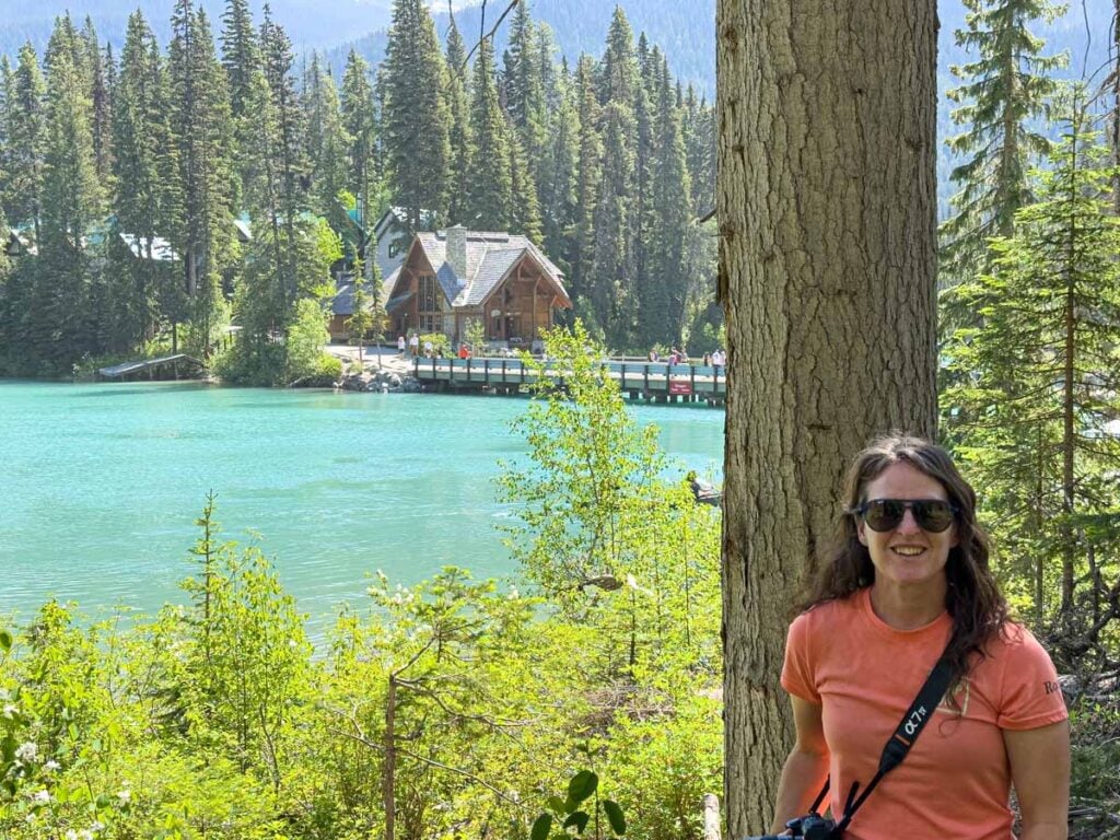 Celine Brewer, host of the Banff Travel Podcast, enjoys the views from the Emerald Lakeshore Trail on the west side of the lake.