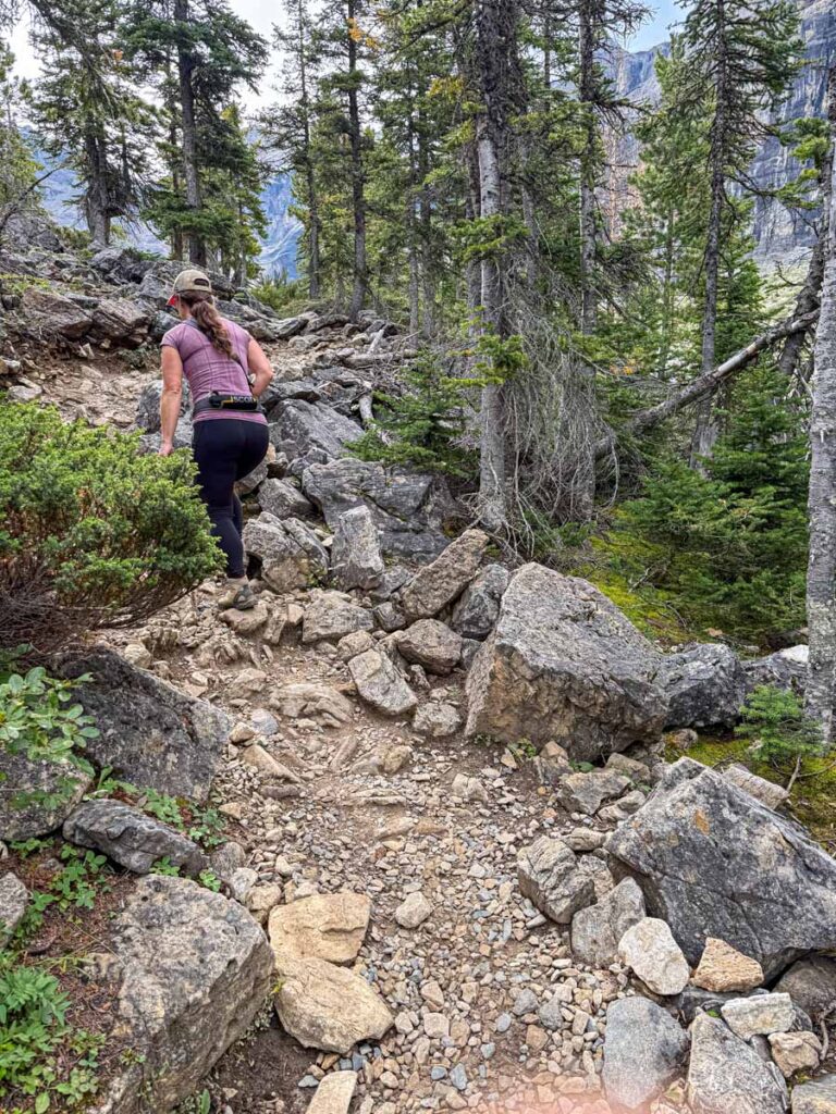 Celine Brewer, host of the Banff Travel Podcast, hikes a steep, rocky section of the Stanley Glacier hiking trail.