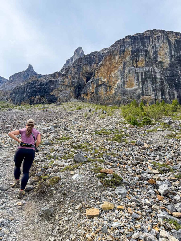 Celine Brewer, host of the Banff Travel Podcast, hikes a steep section of the Stanley Glacier hike.