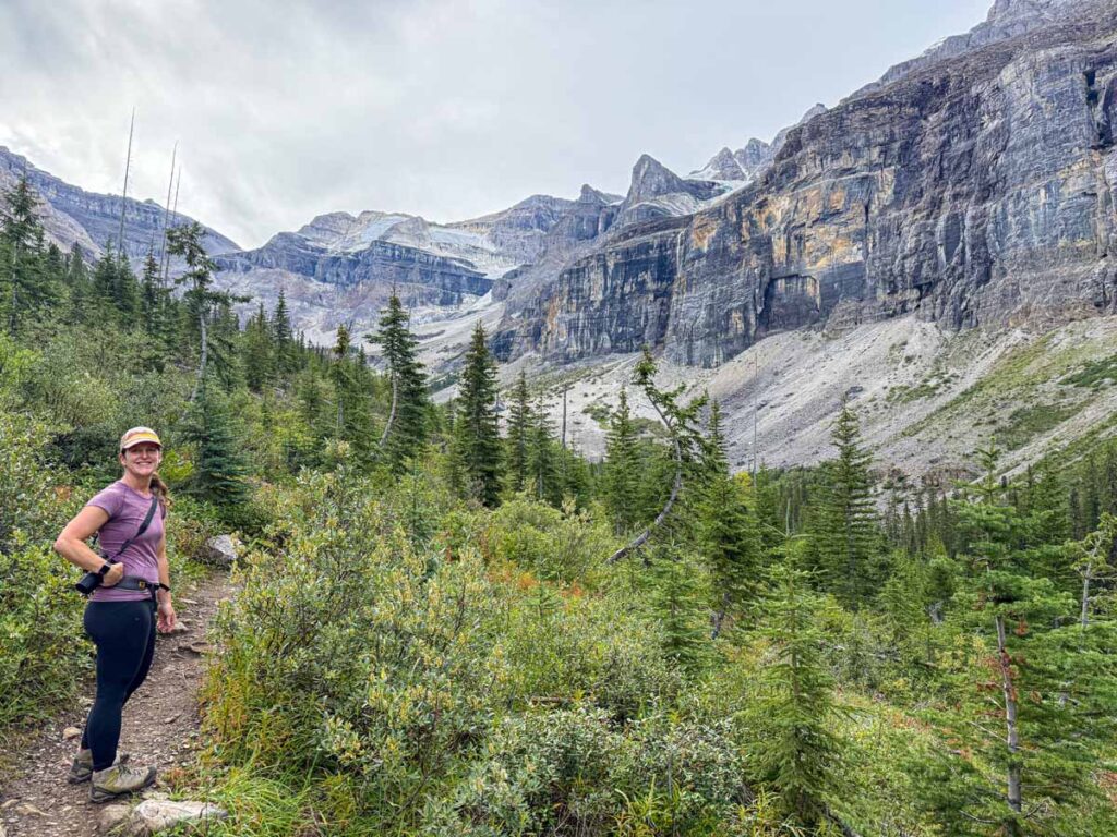 Celine Brewer hiking through a section of new forest in a rockslide path on the Stanley Glacier Trail.