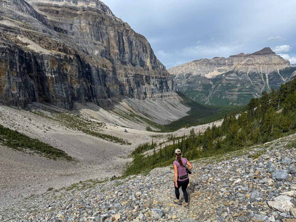 Celine Brewer, owner of TravelBanffCanada.com, hikes downhill through scree on the Stanley Glacier hiking trail.