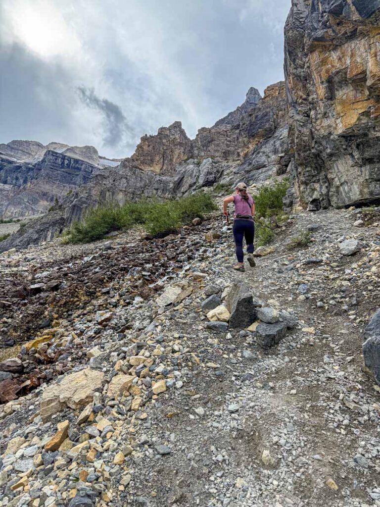 Celine Brewer hikes a steep section of the Stanley Glacier Trail carefully watching her footing.